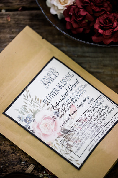 .5oz bag of Flower Blessing, on a brown background with flowers surrounding.