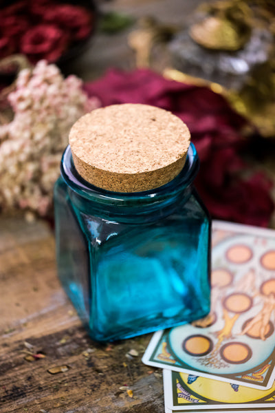 Blue apothecary jar with cork.