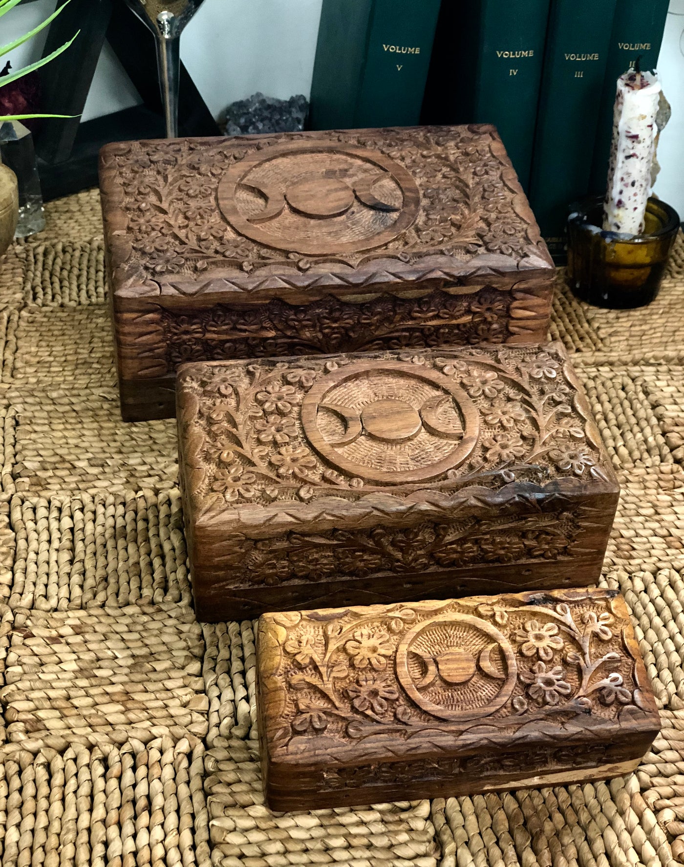 Three wooden boxes with the triple moon carved on the top.