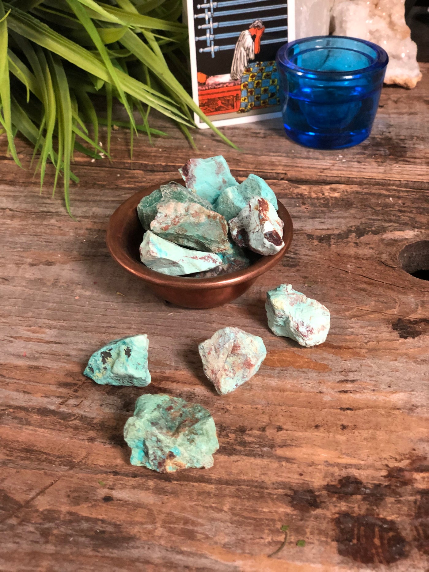 Light Green Chrysocolla spread on a table and in a bowl.