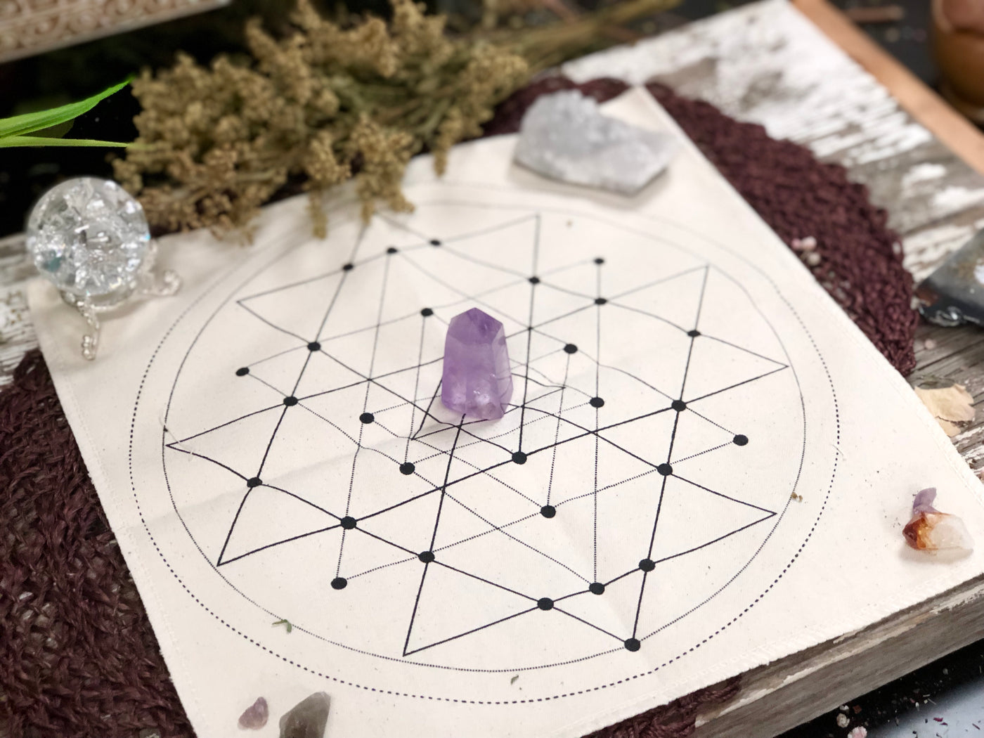 Tan geometric grid cloth with a amethyst tower in the center.