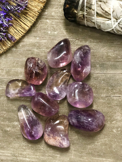 Ten polished orange and purple ametrine. 